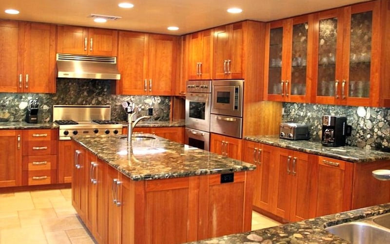 Spacious kitchen with cherry wood cabinets, granite countertops, stainless steel appliances, and central island